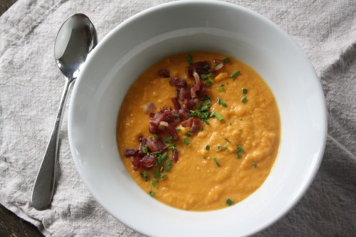 Sweet potato and bacon soup on grey placemat