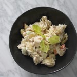 tuna pasta salad in black bowl on marble counter