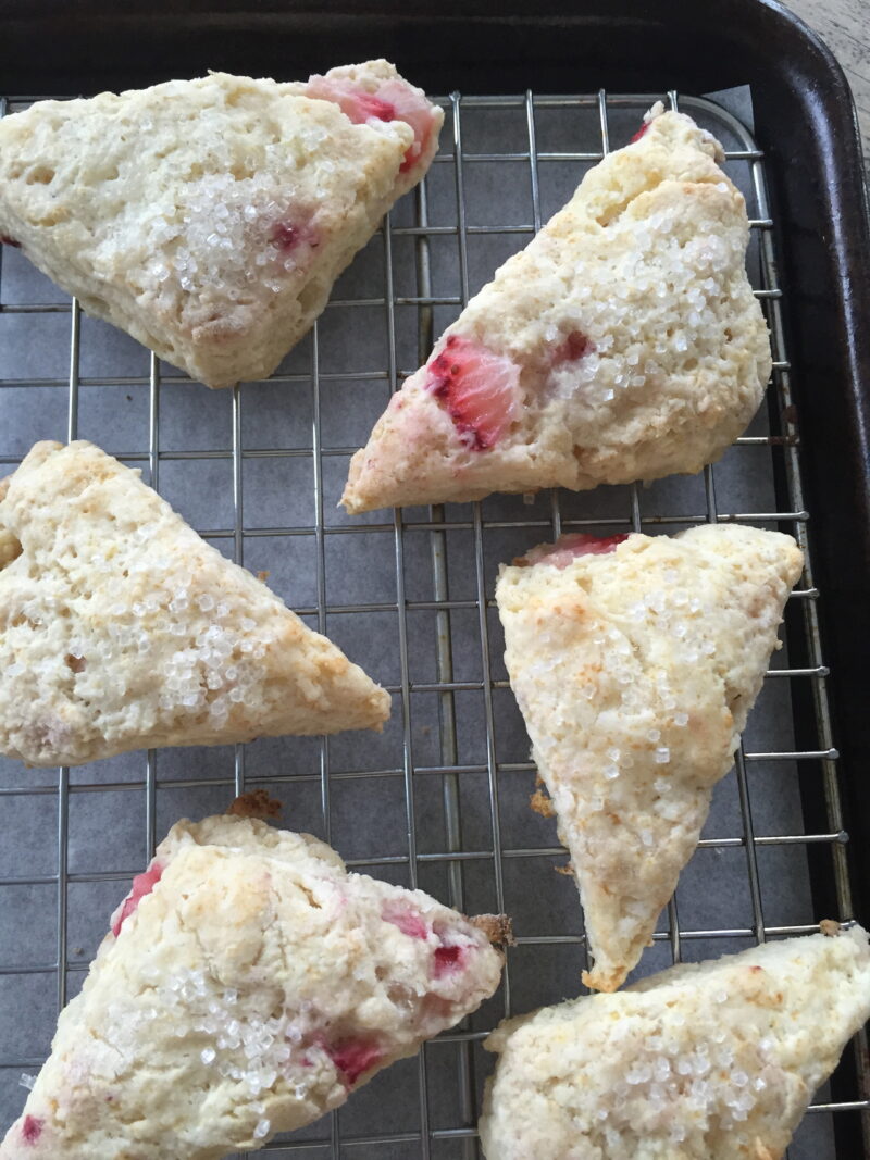 strawberry scone with rhubarb glaze on cooling rack