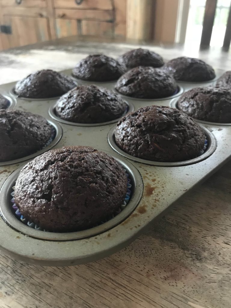 chocolate zucchini muffins in pan on table