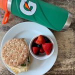 sheet pan egg sandwich with berries and a gatorade water bottle