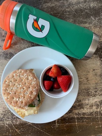 sheet pan egg sandwich with berries and a gatorade water bottle