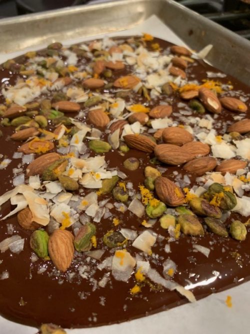 chocolate bark with almonds, pistachios, coconut, and cinnamon