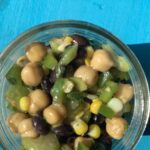 bean salad in bowl with blue background